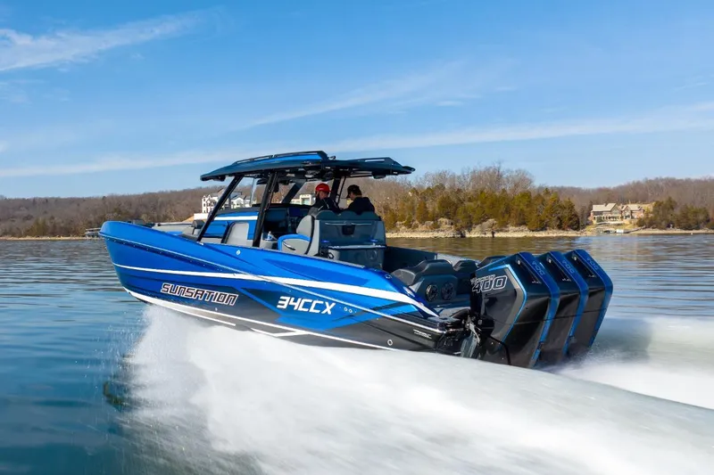 Slide: The Image of 2026 Sunsation 34 CCX speedboat cruising on a lake with powerful engines. - 33