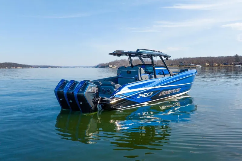 Slide: The Image of 2026 Sunsation 34 CCX boat on calm lake with triple outboard engines. - 37
