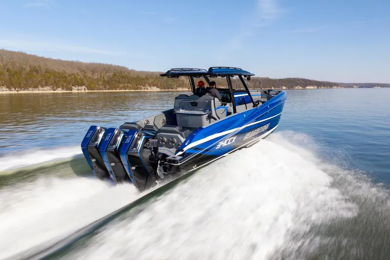 Slide: The Image of 2026 Sunsation 34 CCX speedboat cruising on a lake with powerful engines. - 40