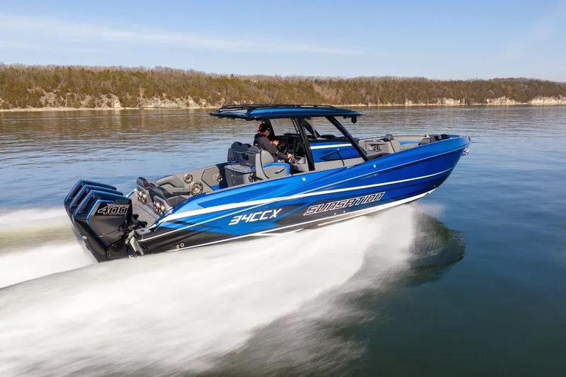 Slide: The Image of 2026 Sunsation 34 CCX speedboat cruising on a calm lake, showcasing sleek design and power. - 43