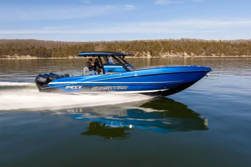 Slide: The Image of 2026 Sunsation 34 CCX speedboat cruising on a calm lake under clear skies. - 44