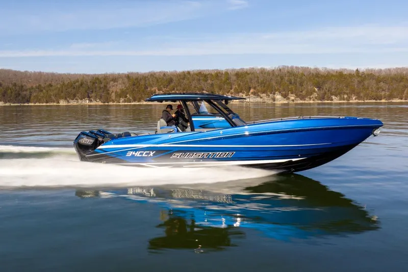 Slide: The Image of 2026 Sunsation 34 CCX speedboat cruising on a calm lake. - 45