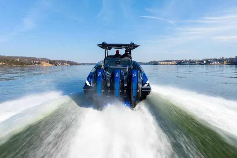 Slide: The Image of 2026 Sunsation 34 CCX speedboat cruising on a clear lake under blue skies. - 48