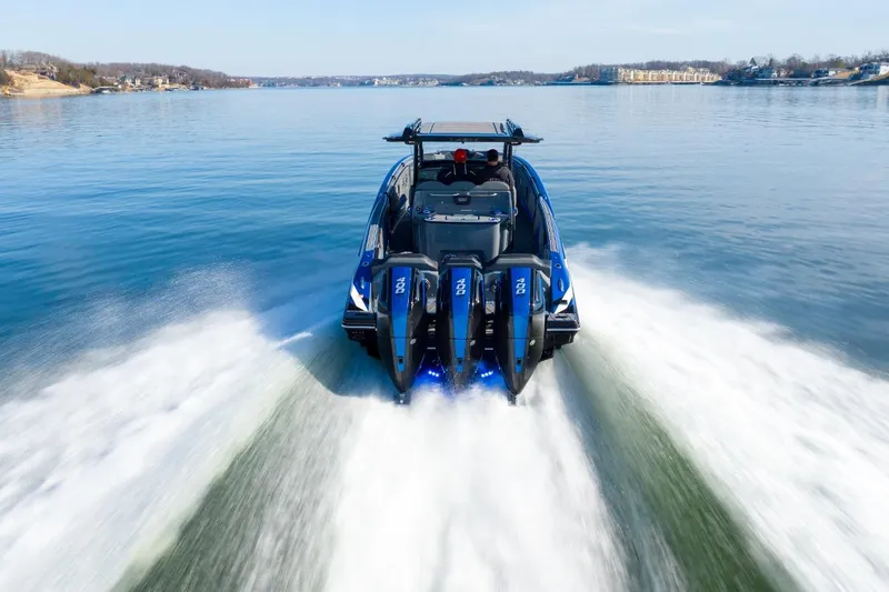 Slide: The Image of 2026 Sunsation 34 CCX speedboat cruising on a serene lake. - 49