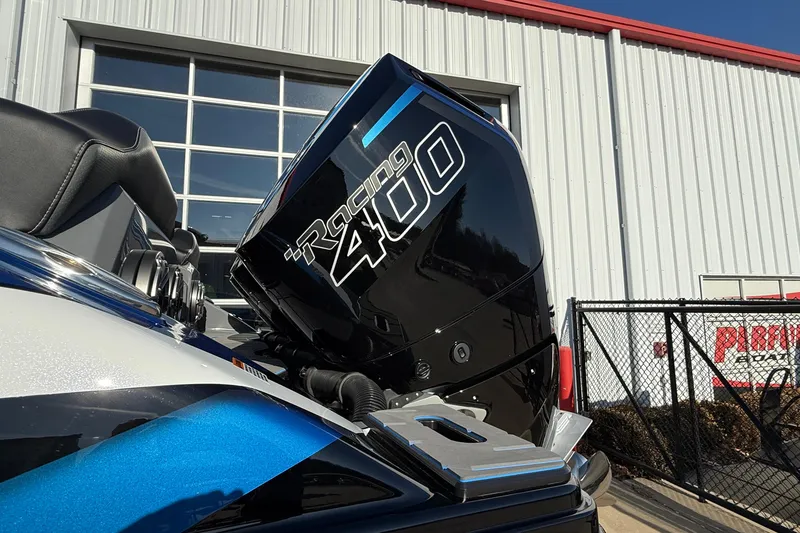 Slide: The Image of 2026 Sunsation 34 CCX with Racing 400 engine, parked near a modern building. - 5