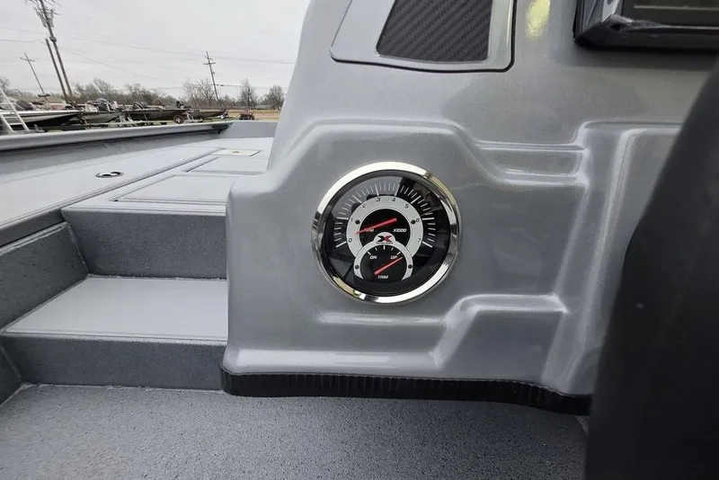 Slide: The Image of 2026 Xpress H17C Crappie boat dashboard with gauge, sleek gray interior design. - 10