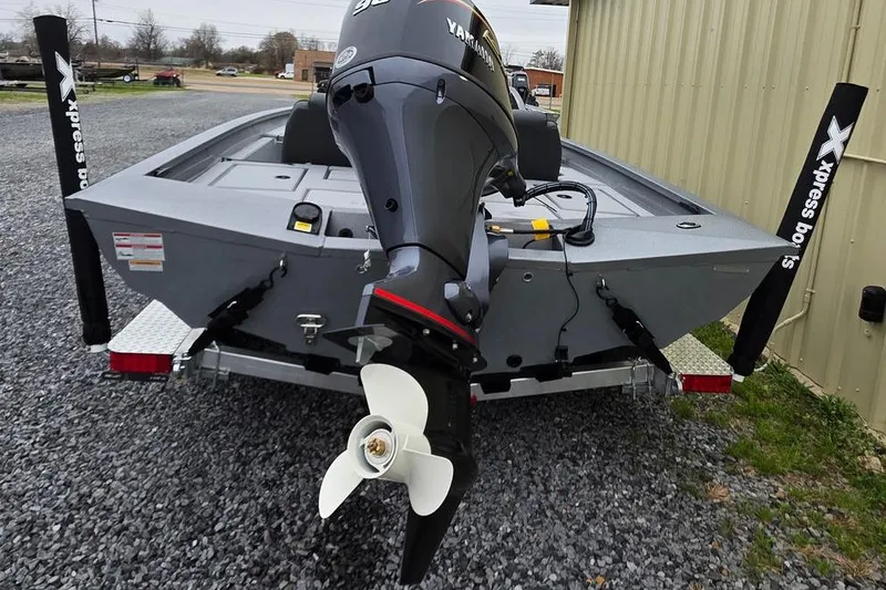 Slide: The Image of 2026 Xpress H17C Crappie boat with Yamaha motor, parked on gravel. - 20