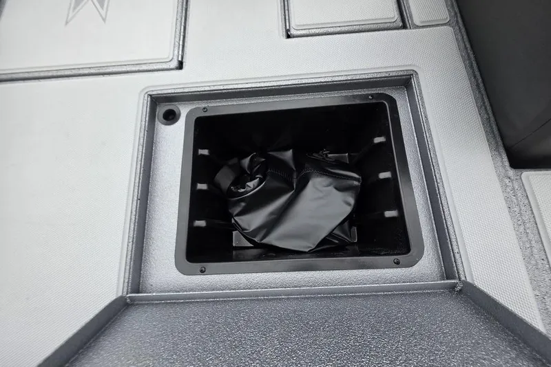 Slide: The Image of 2026 Xpress H17C Crappie boat storage compartment with black liner. - 3