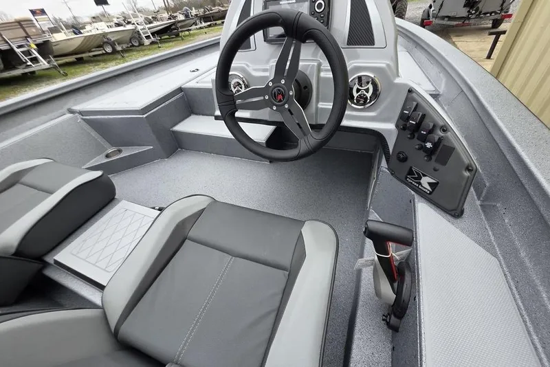 Slide: The Image of 2026 Xpress H17C Crappie boat interior with steering wheel and seating. - 5