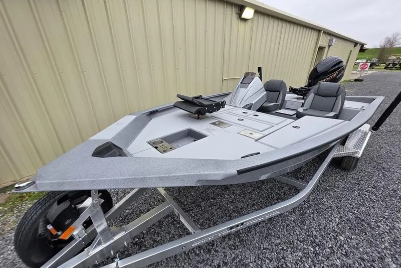 Slide: The Image of 2026 Xpress H17C Crappie fishing boat on trailer, parked near a beige building. - 8