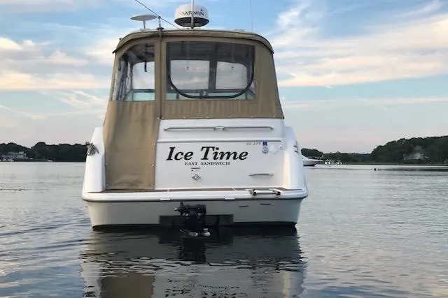 The Image of 2003 Glastron GS 279 boat named "Ice Time" on calm water at sunset. - 1