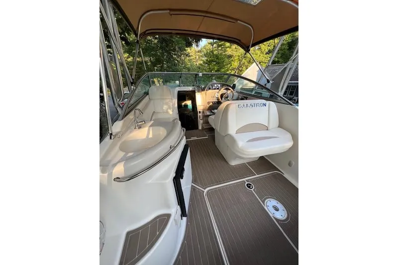 Slide: The Image of 2003 Glastron GS 279 boat interior with seating and helm, featuring a canopy. - 6