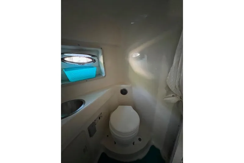 Slide: The Image of 2003 Glastron GS 279 boat bathroom interior with toilet and sink. - 7