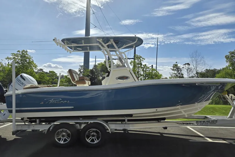 The Image of 2026 Pioneer 222 Islander boat on trailer, blue hull, sunny day, outdoor setting. - 0