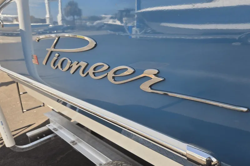 Slide: The Image of 2026 Pioneer 222 Islander boat with sleek blue exterior and chrome logo. - 1