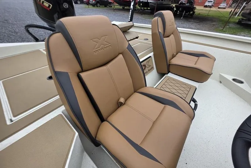 Slide: The Image of 2026 Xpress H18C Crappie boat interior with tan and black seating. - 12