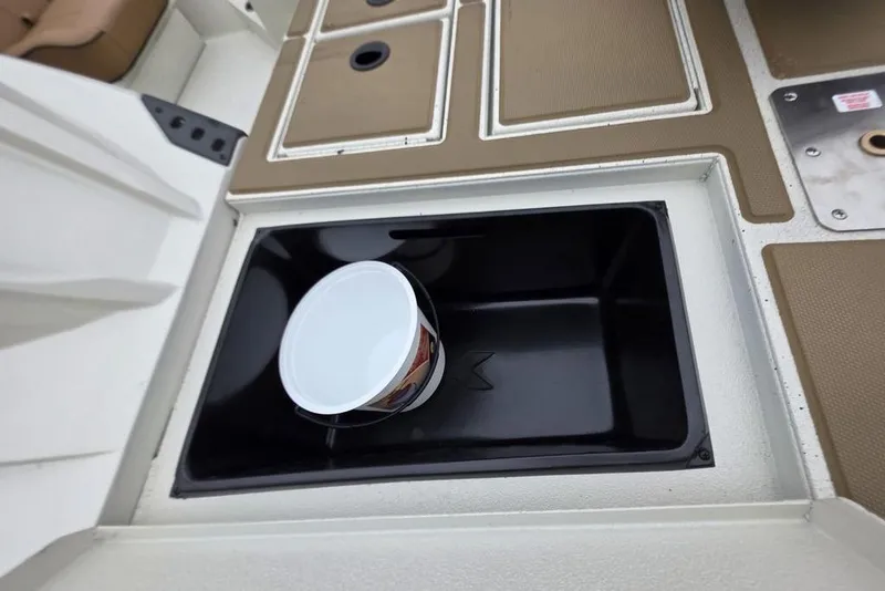 Slide: The Image of 2026 Xpress H18C Crappie boat interior with storage compartment and bucket. - 14