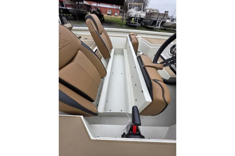 Slide: The Image of 2026 Xpress H18C Crappie boat interior with tan seating and storage compartment. - 15