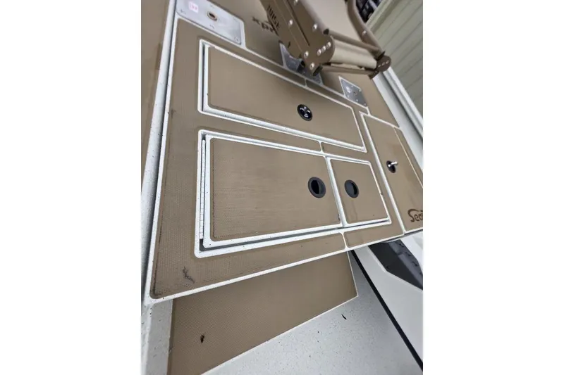 Slide: The Image of 2026 Xpress H18C Crappie boat deck with storage compartments and seating. - 18