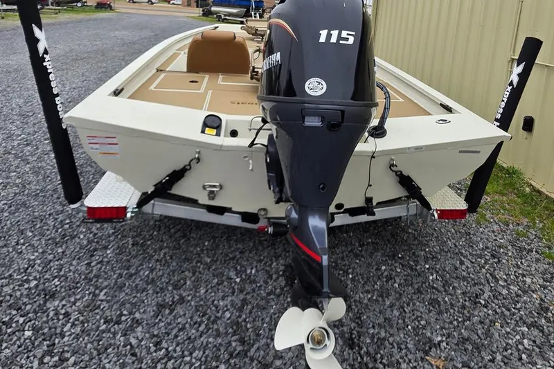 Slide: The Image of 2026 Xpress H18C Crappie boat with Yamaha 115 outboard motor, on gravel surface. - 3