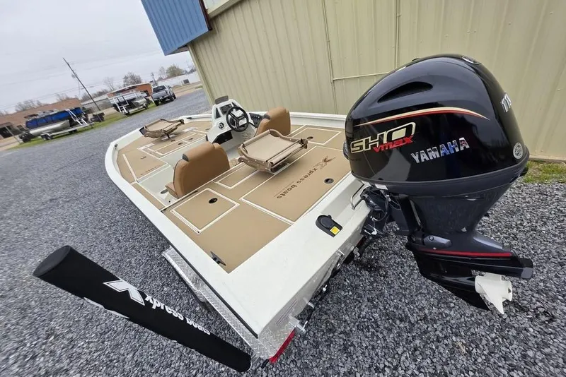 Slide: The Image of 2026 Xpress H18C Crappie boat with Yamaha engine, parked on gravel. - 6