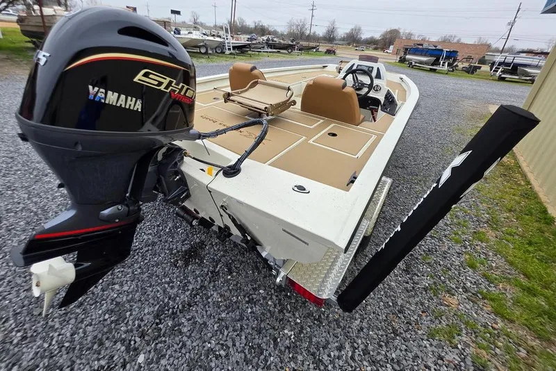 Slide: The Image of 2026 Xpress H18C Crappie boat with Yamaha engine, parked on gravel. - 7