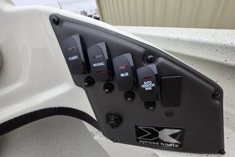 Slide: The Image of Control panel of 2026 Xpress H18C Crappie boat with labeled switches. - 8