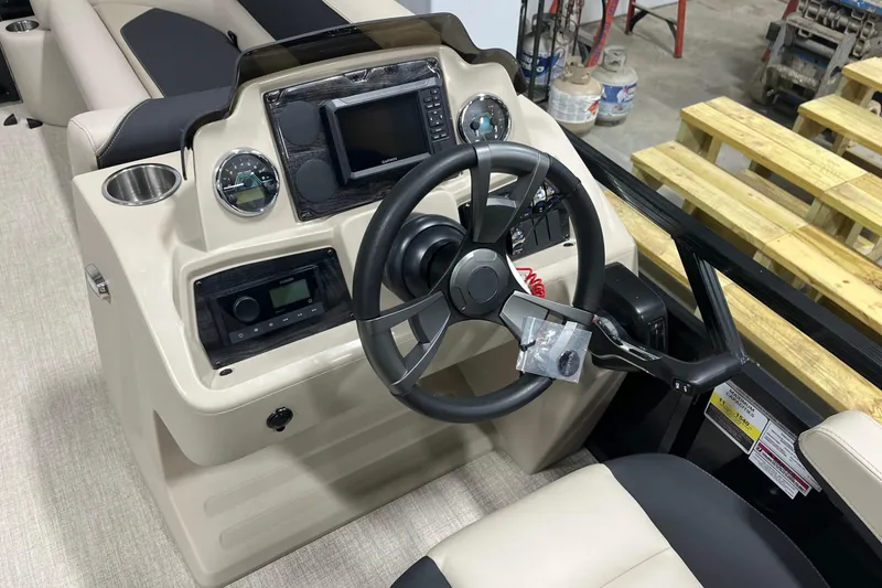 Slide: The Image of 2026 Tahoe Pontoon Sport 85 Versatile Rear Bench 23 dashboard with steering wheel and controls. - 11