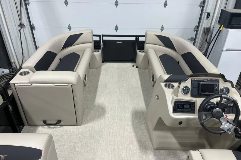 Slide: The Image of 2026 Tahoe Pontoon Sport 85 Versatile Rear Bench 23 interior with beige seating and modern dashboard. - 13