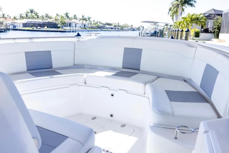 Slide: The Image of 2023 Pursuit S 328 Sport boat interior with spacious seating and waterfront view. - 13