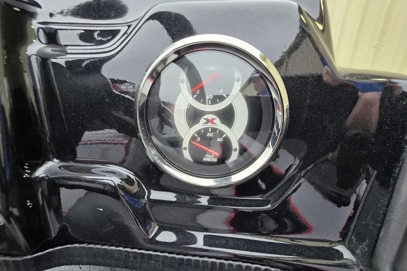 Slide: The Image of Close-up of 2026 Xpress H17 dashboard gauges, showing fuel and pressure indicators. - 13