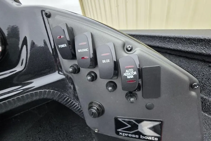 Slide: The Image of Control panel of 2026 Xpress H17 boat with labeled switches and logo. - 14