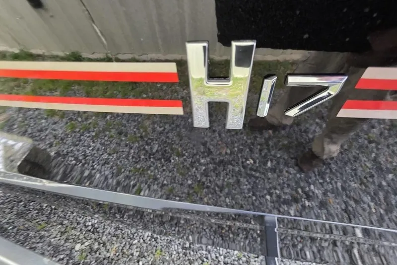 Slide: The Image of 2026 Xpress H17 model emblem with red stripes on a reflective surface. - 21