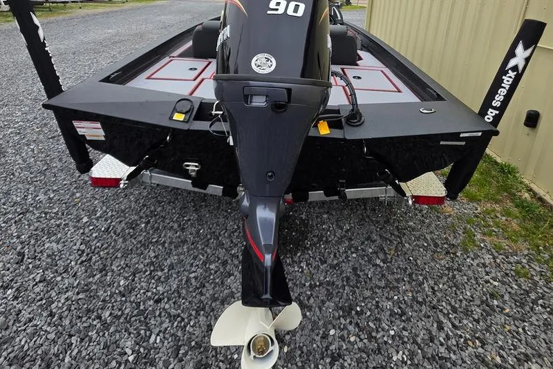 Slide: The Image of 2026 Xpress H17 boat rear view with powerful outboard motor on gravel surface. - 4