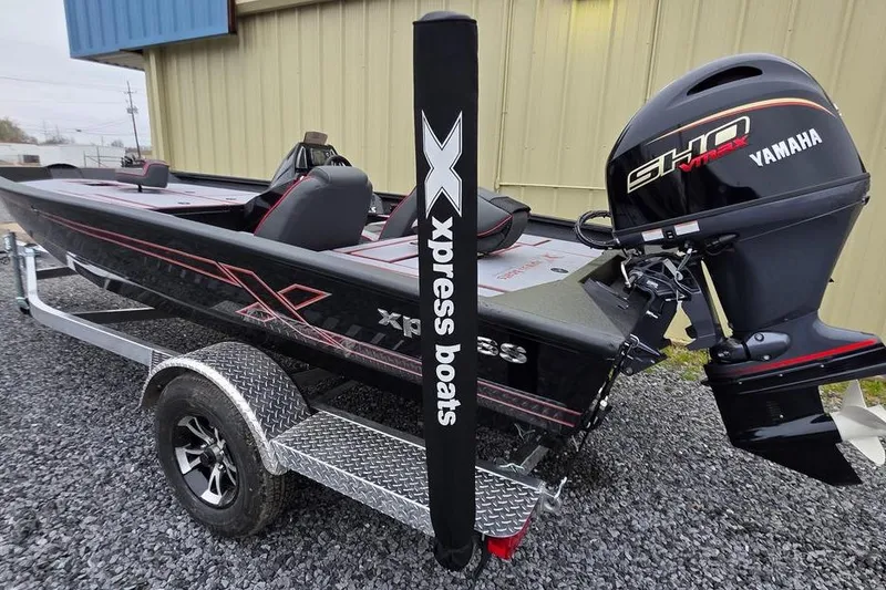Slide: The Image of 2026 Xpress H17 boat with Yamaha engine on a trailer, parked outdoors. - 8