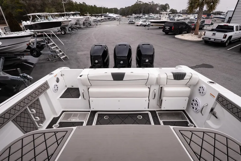 Slide: The Image of 2023 Wellcraft 352 Fisherman boat with triple outboard engines in a marina setting. - 12
