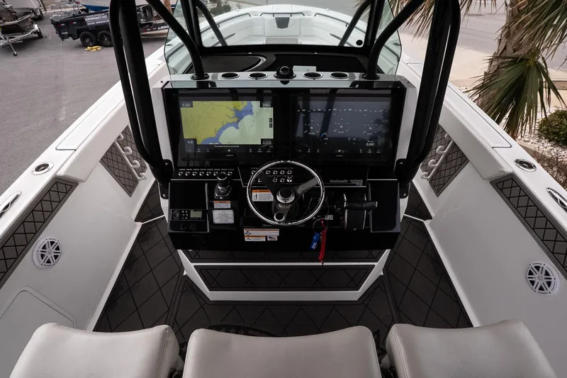 Slide: The Image of 2023 Wellcraft 352 Fisherman boat cockpit with advanced navigation displays and steering wheel. - 16