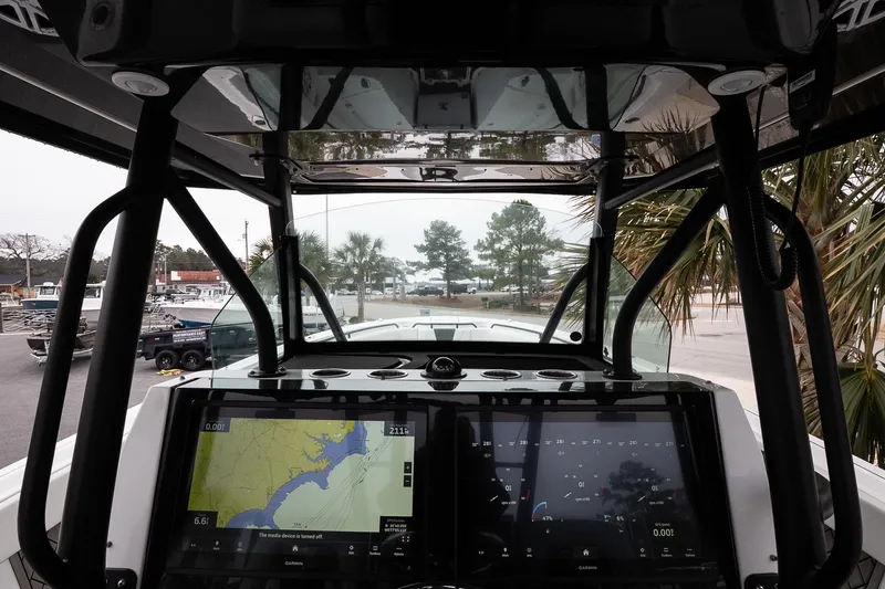 Slide: The Image of 2023 Wellcraft 352 Fisherman dashboard with navigation screens and outdoor view. - 19