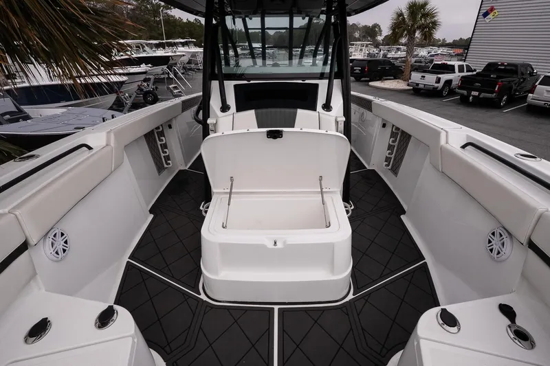Slide: The Image of 2023 Wellcraft 352 Fisherman boat interior with open storage compartment, sleek design. - 25