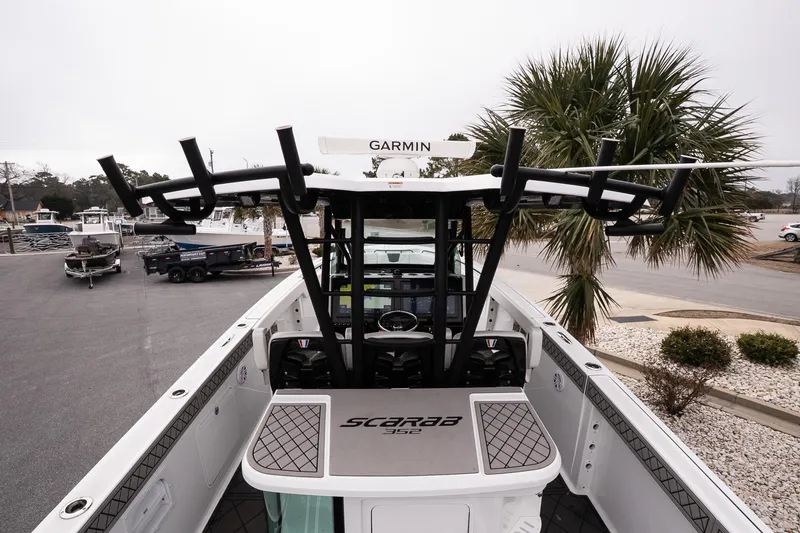 Slide: The Image of 2023 Wellcraft 352 Fisherman boat with Garmin equipment, docked near palm trees. - 28