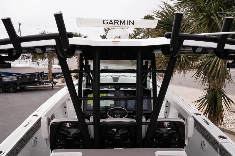 Slide: The Image of 2023 Wellcraft 352 Fisherman boat interior with Garmin navigation system, palm trees in background. - 29