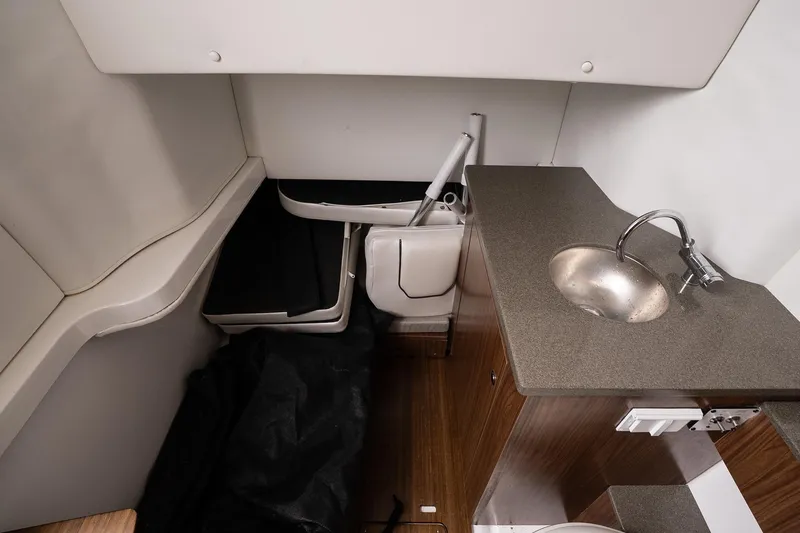 Slide: The Image of 2023 Wellcraft 352 Fisherman cabin interior with sink and storage area. - 35