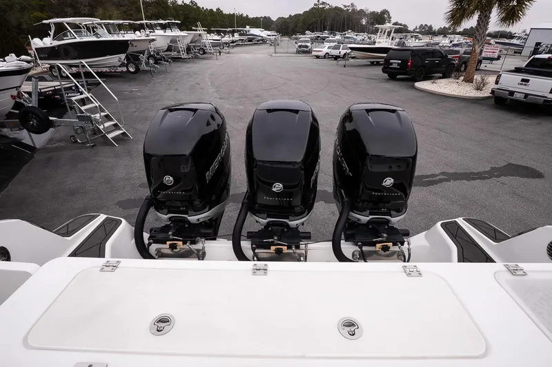 Slide: The Image of 2023 Wellcraft 352 Fisherman with triple Mercury outboard engines at a marina. - 8