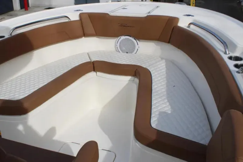 Slide: The Image of 2026 Pioneer 270 Pelagic boat interior with brown and white seating, featuring a speaker. - 10