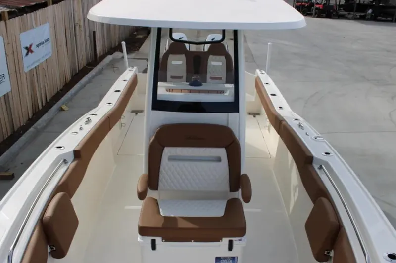 Slide: The Image of 2026 Pioneer 270 Pelagic boat interior with brown seating and modern design. - 11