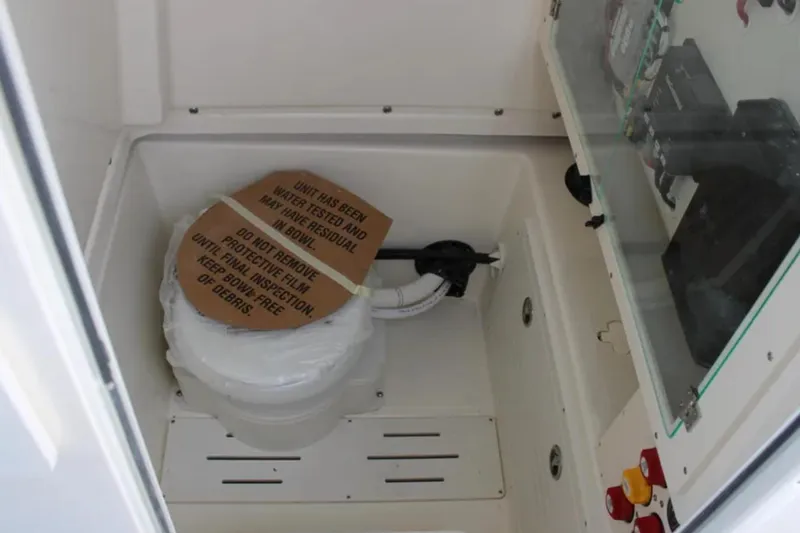 Slide: The Image of Marine toilet in 2026 Pioneer 270 Pelagic boat, covered for inspection. - 12