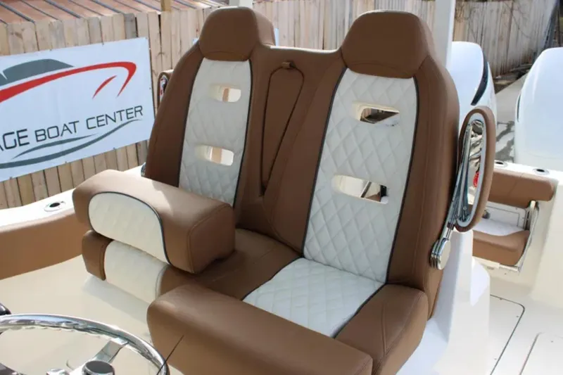 Slide: The Image of 2026 Pioneer 270 Pelagic boat seats with brown and white quilted design. - 9