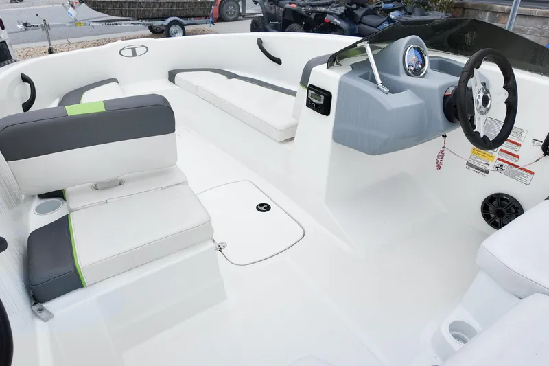 Slide: The Image of 2021 Tahoe T16 boat interior with white seating and modern dashboard design. - 11