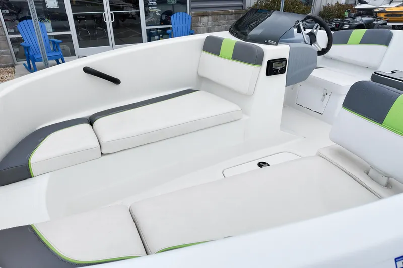 Slide: The Image of 2021 Tahoe T16 boat interior with white and green seating, modern design. - 14
