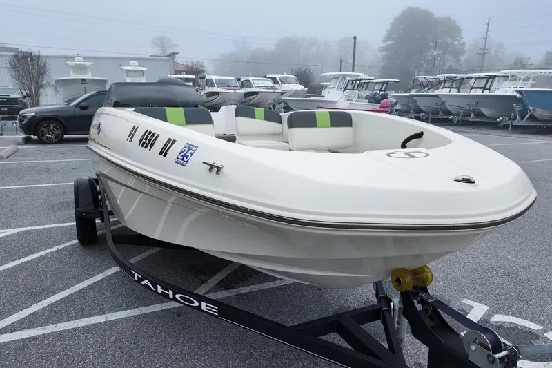 Slide: The Image of 2021 Tahoe T16 boat on trailer in foggy parking lot. - 3